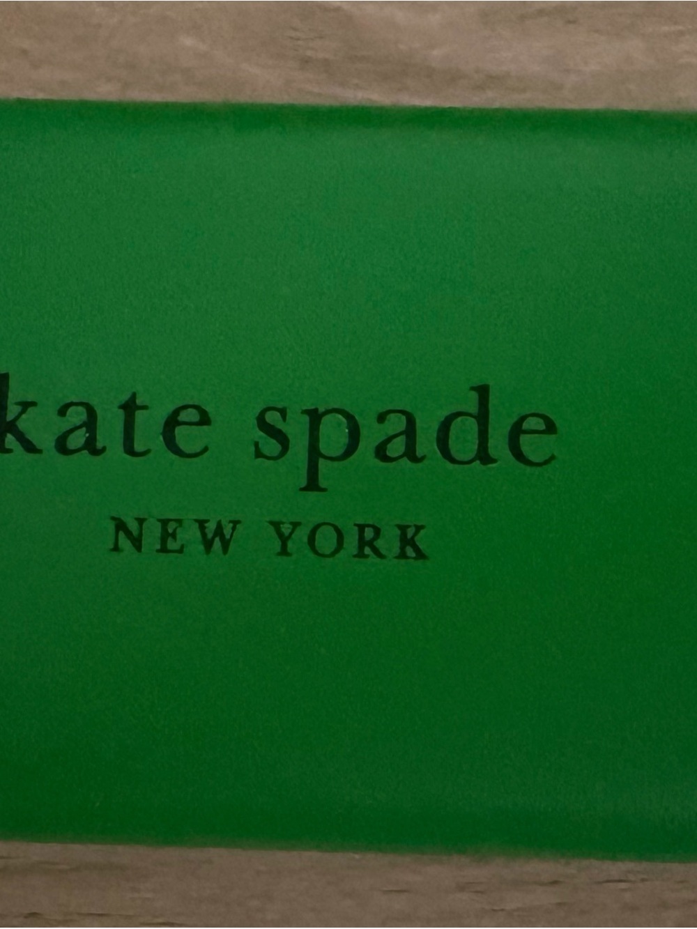 kate spade green logo box with black text